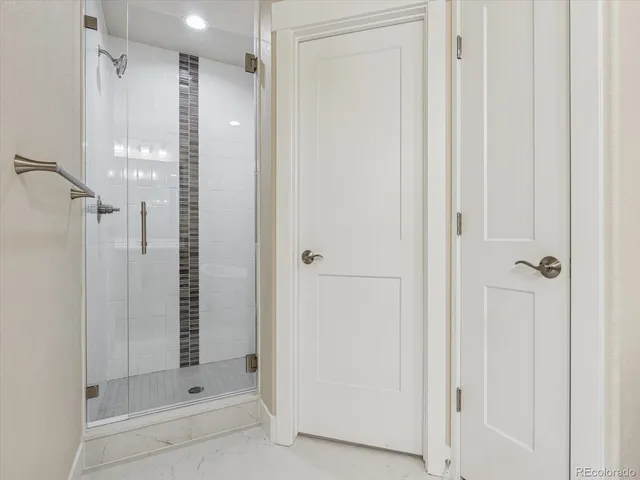 a bathroom with a shower and a glass door