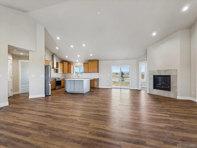 a view of a living room with furniture and fireplace