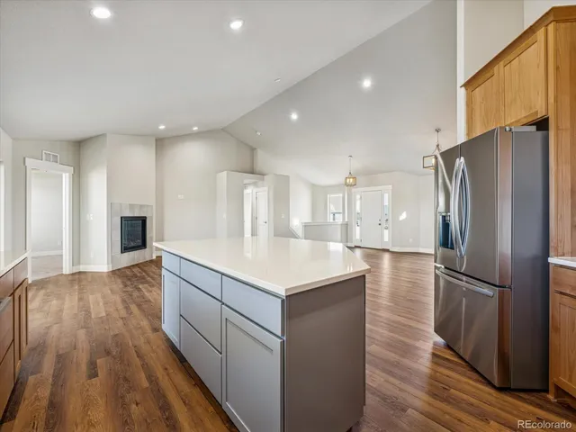 a kitchen with kitchen island white cabinets and stainless steel appliances