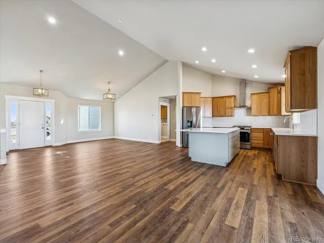 a view of kitchen and hall with wooden floor