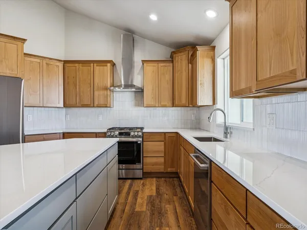 a kitchen with a sink a stove and cabinets