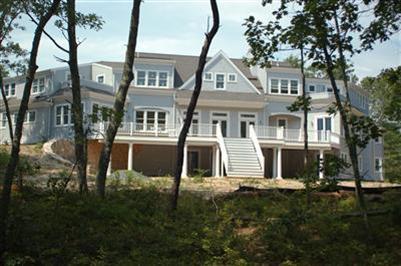 Undisclosed Address Mashpee, MA 02649 - Photo 2 of 18 a front view of a house with a yard