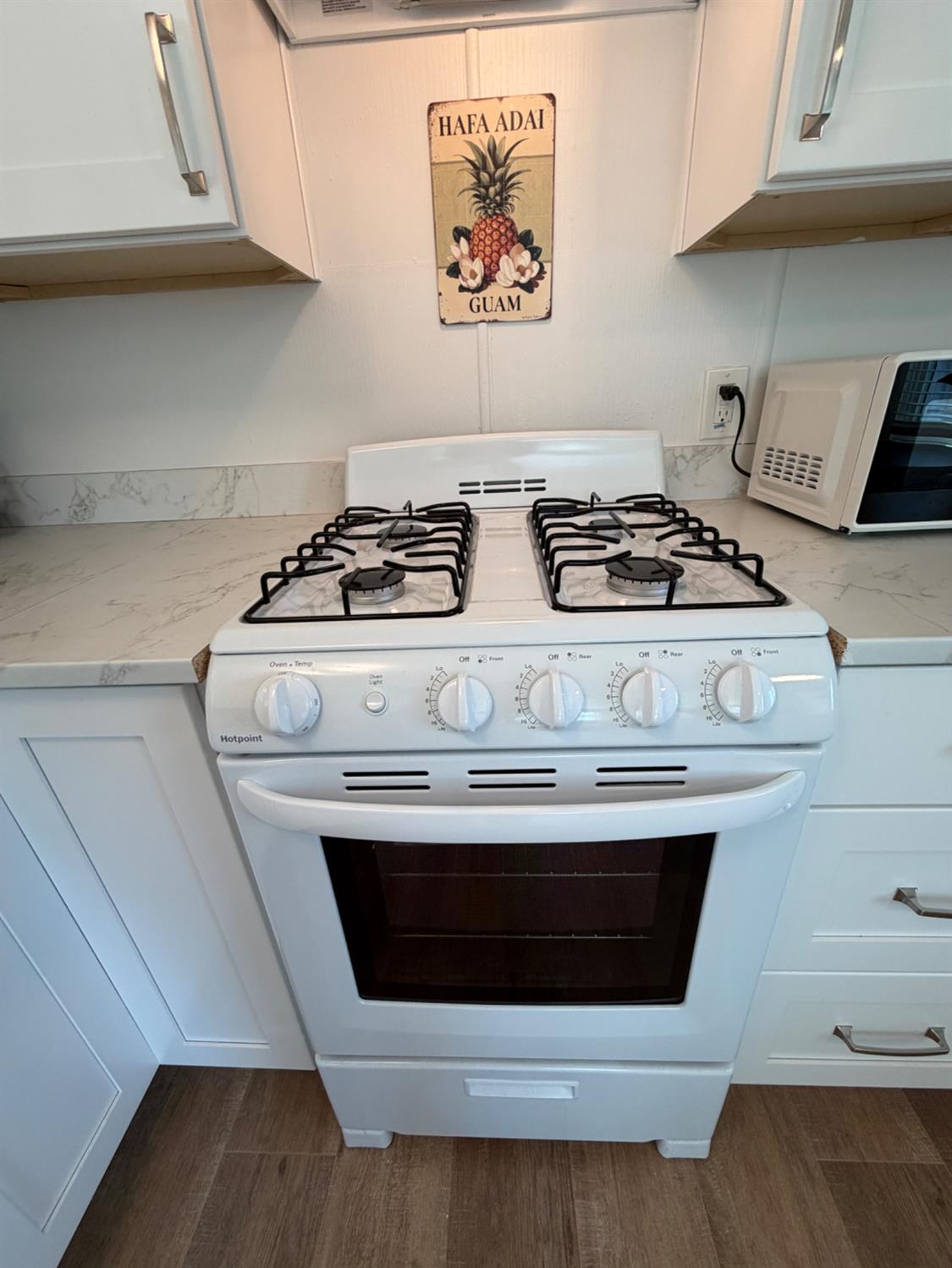 9060 Auburn Folsom Road, Unit 19 Granite Bay, CA 95746 - Photo 9 of 30 a stove top oven sitting inside of a kitchen