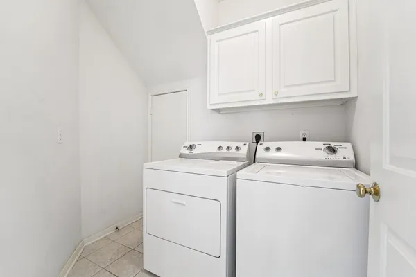a kitchen with granite countertop white cabinets and appliances
