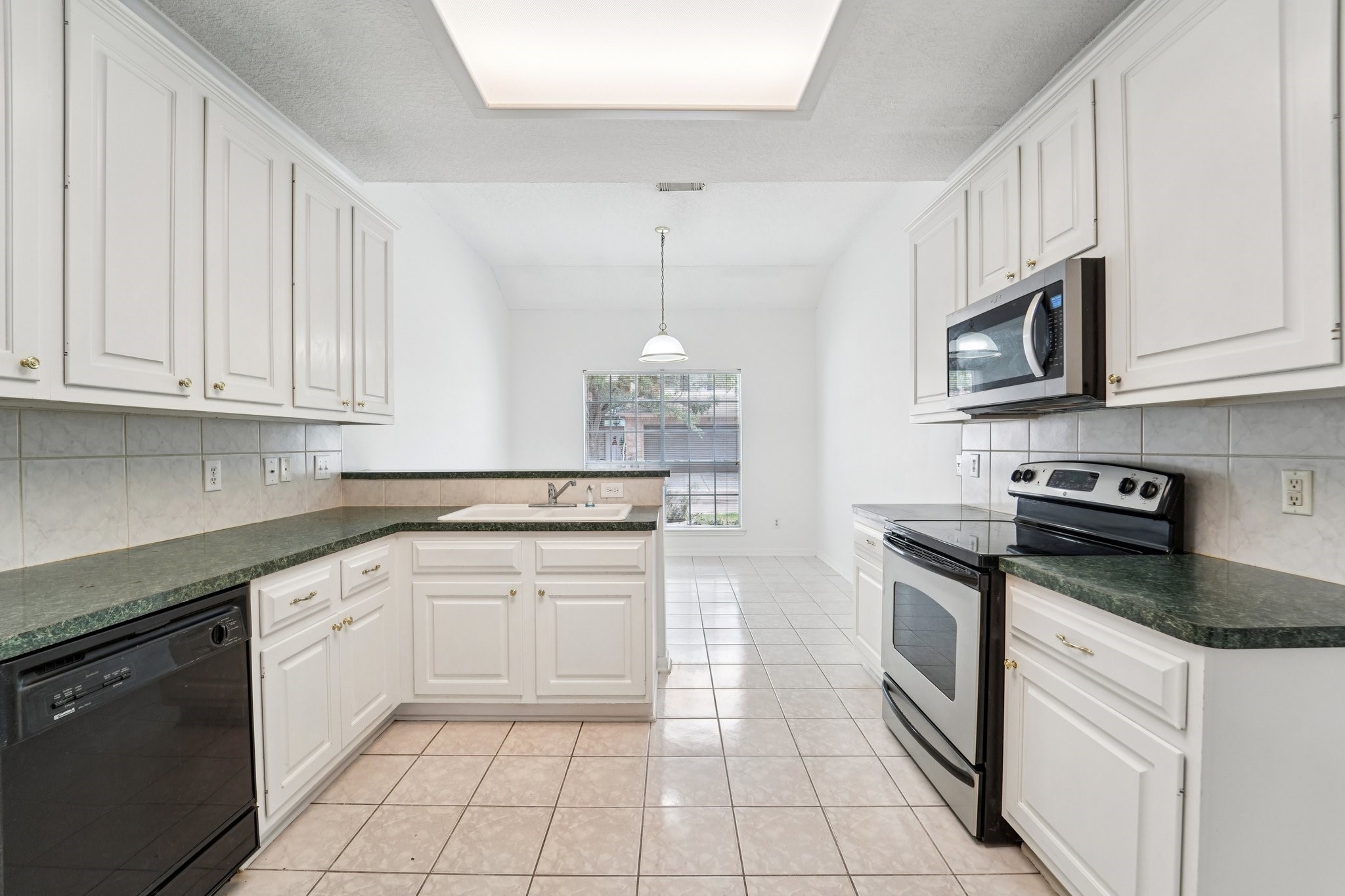 14420 Walters Road, Unit 55 Houston, TX 77014 - Photo 16 of 35 a kitchen with granite countertop white cabinets white stainless steel appliances with a sink and dishwasher