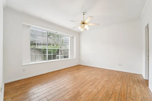 a view of walk in closet with empty racks