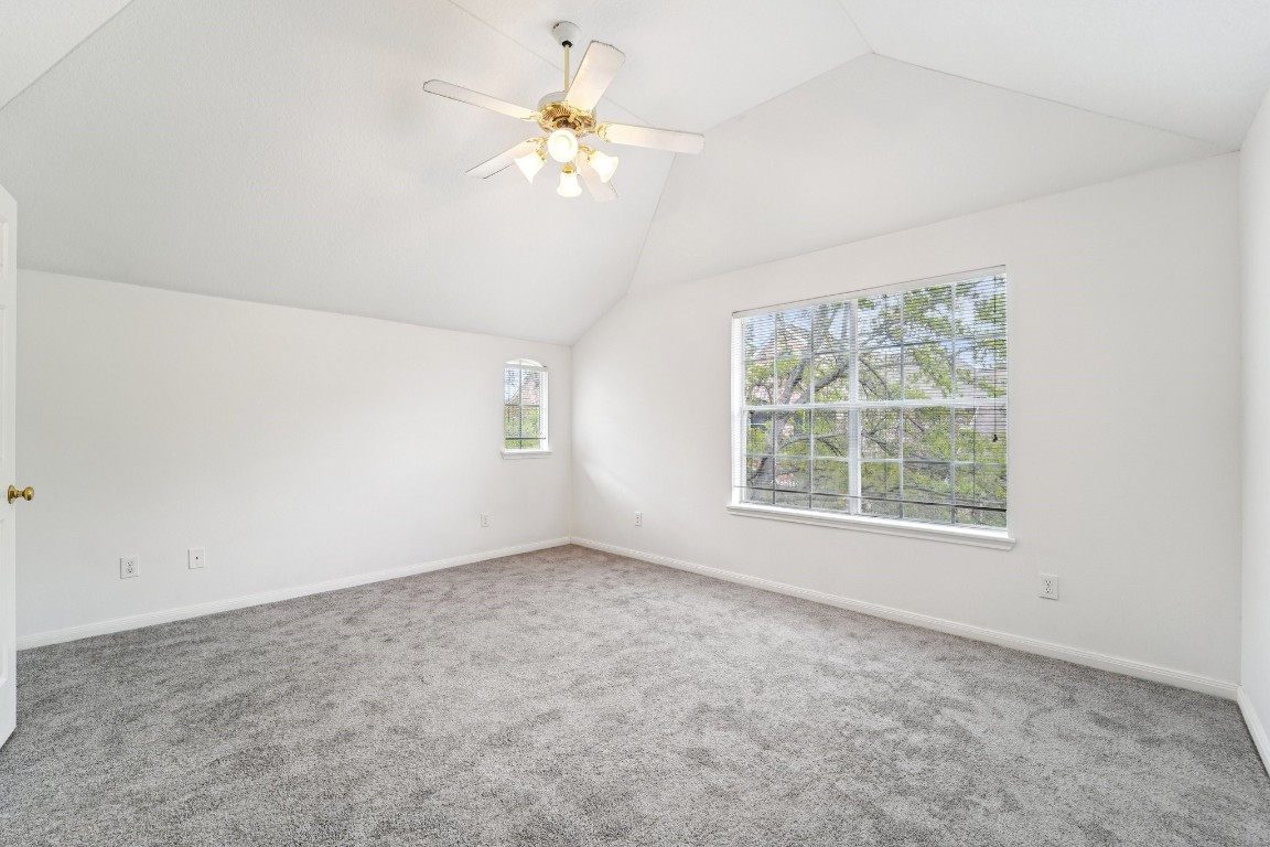 14420 Walters Road, Unit 55 Houston, TX 77014 - Photo 27 of 35 an empty room with a chandelier fan and windows