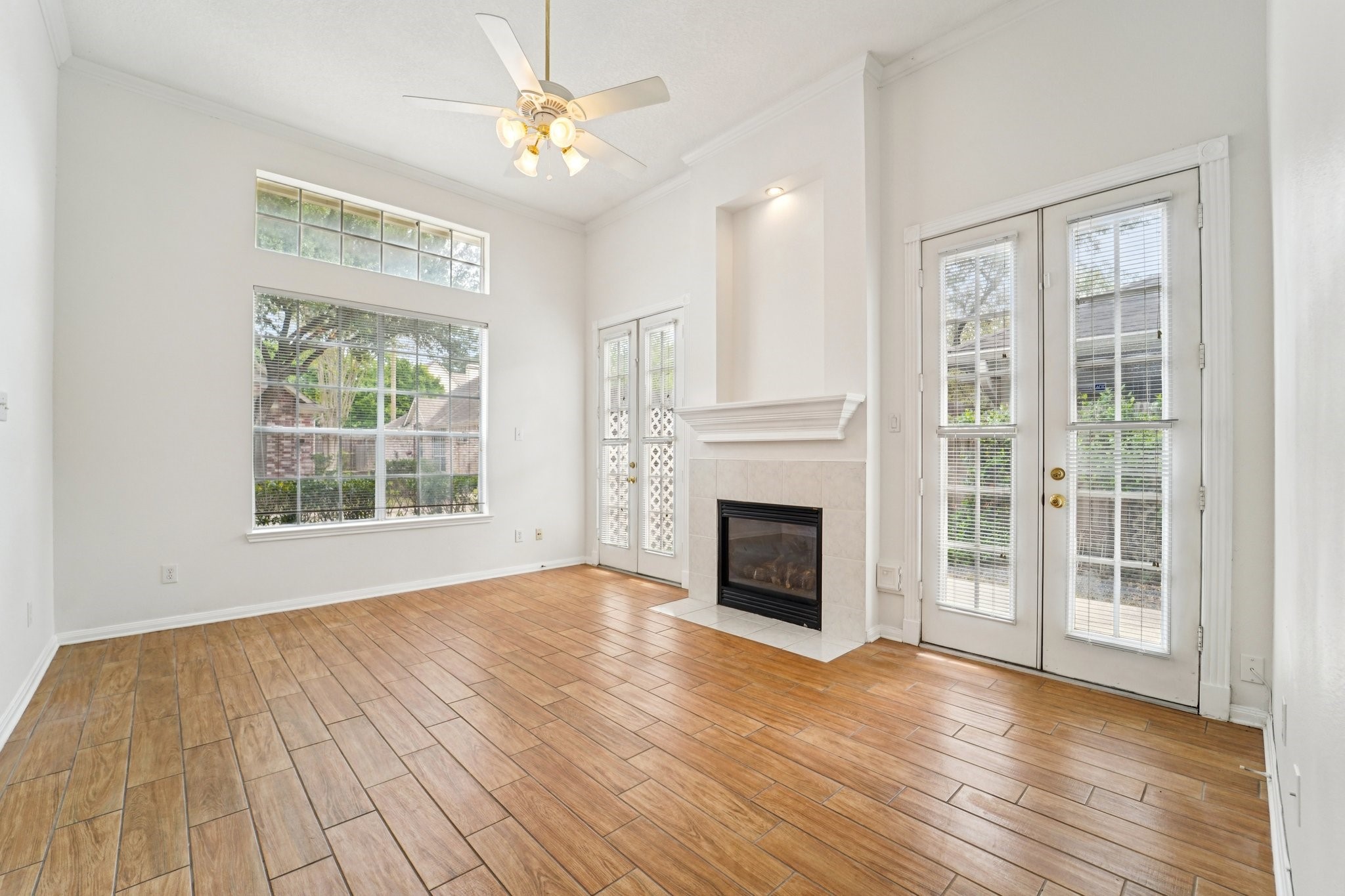 14420 Walters Road, Unit 55 Houston, TX 77014 - Photo 6 of 35 a view of an empty room with wooden floor fireplace and a window