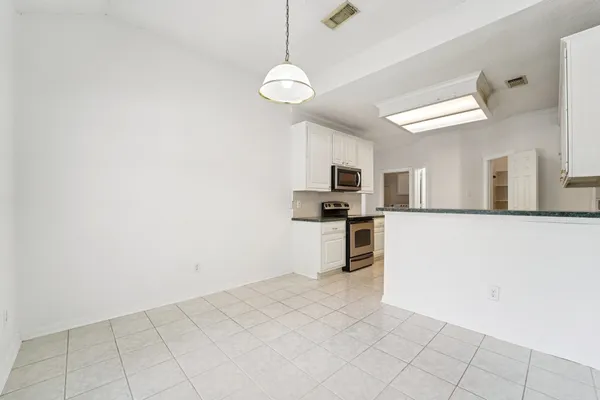 a view of kitchen with sink and refrigerator