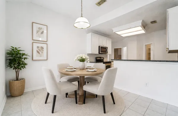 a dining room with furniture and window