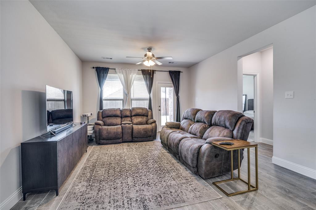 1069 Norias Drive Forney, TX 75126 - Photo 15 of 36 a living room with furniture and a flat screen tv