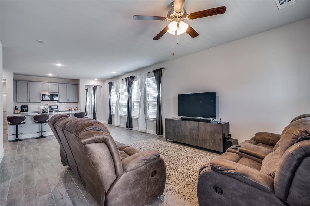1069 Norias Drive Forney, TX 75126 - Photo 16 of 36 a living room with furniture and a flat screen tv