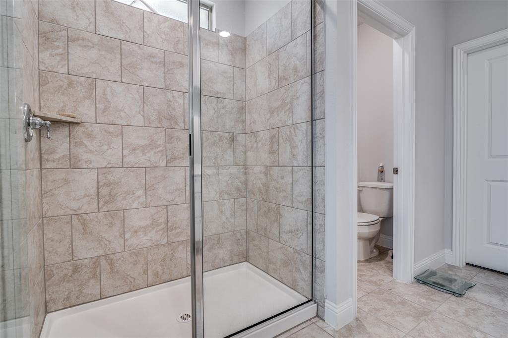 1069 Norias Drive Forney, TX 75126 - Photo 20 of 36 a bathroom with a shower and toilet