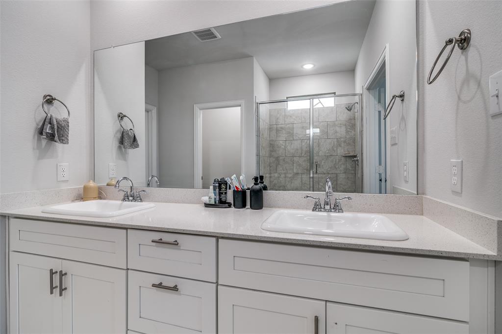 1069 Norias Drive Forney, TX 75126 - Photo 23 of 36 a bathroom with double sink and a mirror