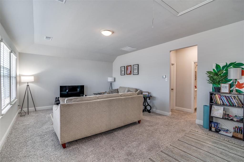1069 Norias Drive Forney, TX 75126 - Photo 24 of 36 a living room with furniture and a flat screen tv