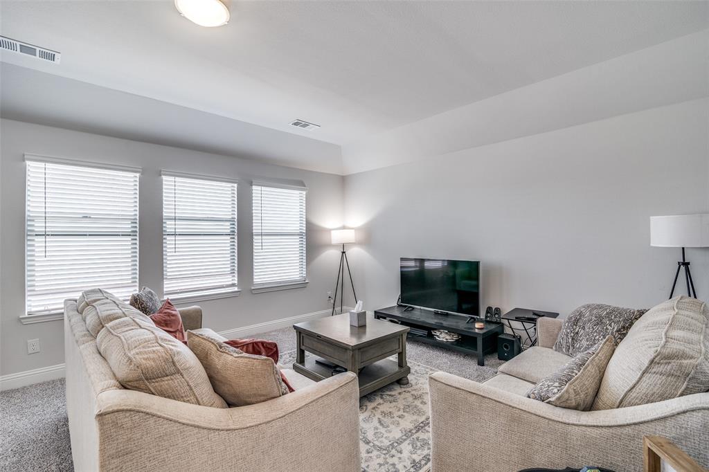 1069 Norias Drive Forney, TX 75126 - Photo 26 of 36 a living room with furniture and a flat screen tv