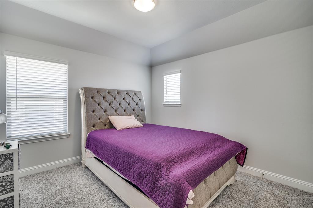 1069 Norias Drive Forney, TX 75126 - Photo 27 of 36 a bed sitting in a bedroom next to a window
