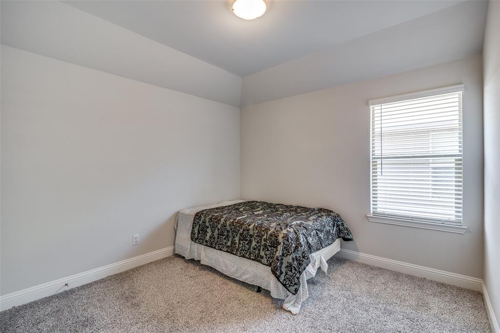 1069 Norias Drive Forney, TX 75126 - Photo 30 of 36 a bedroom with a bed and a window