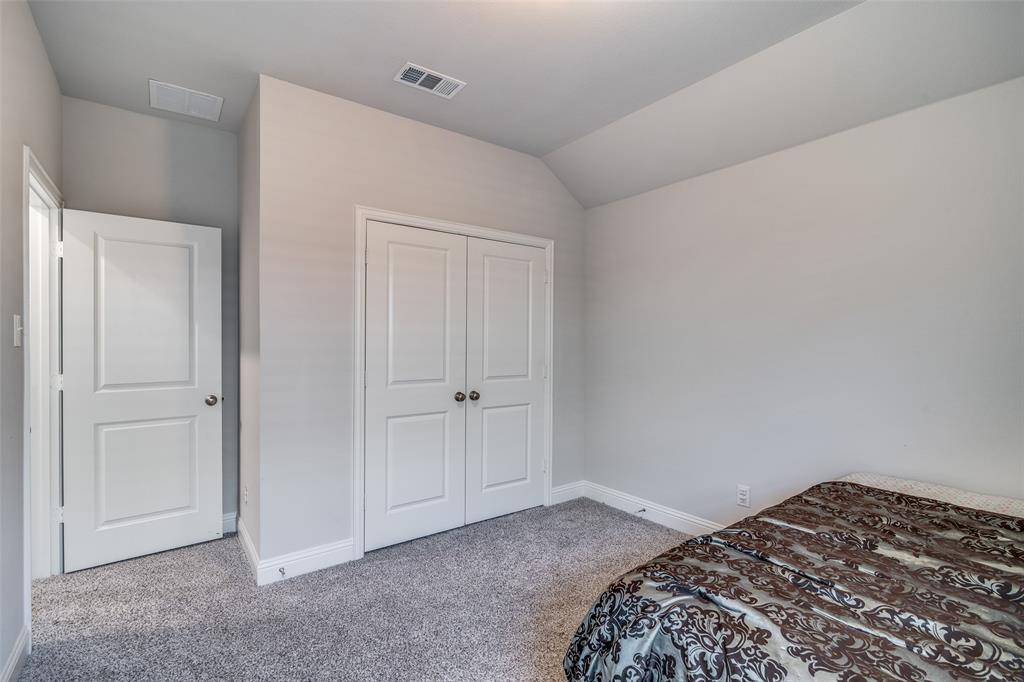 1069 Norias Drive Forney, TX 75126 - Photo 31 of 36 a bedroom with a bed and a closet