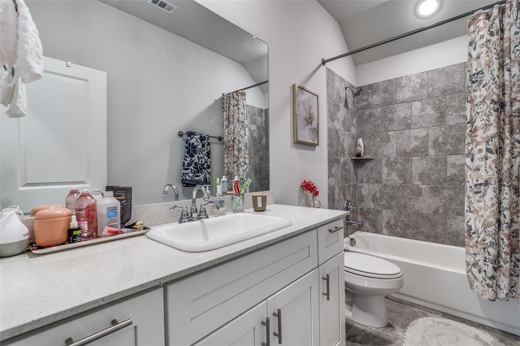 1069 Norias Drive Forney, TX 75126 - Photo 32 of 36 a bathroom with a sink a toilet and shower