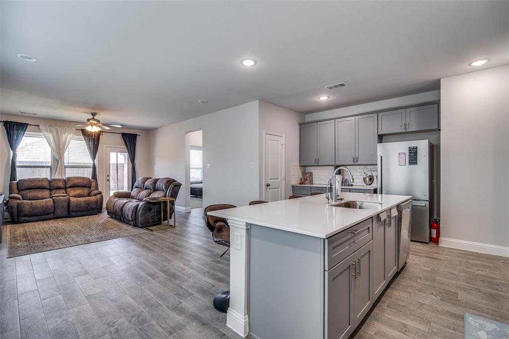 1069 Norias Drive Forney, TX 75126 - Photo 7 of 36 a kitchen with counter top space a sink and a refrigerator