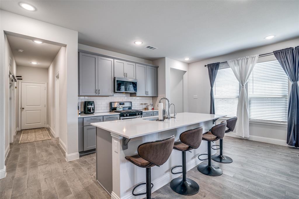1069 Norias Drive Forney, TX 75126 - Photo 10 of 36 a view of kitchen with cabinets table and chairs