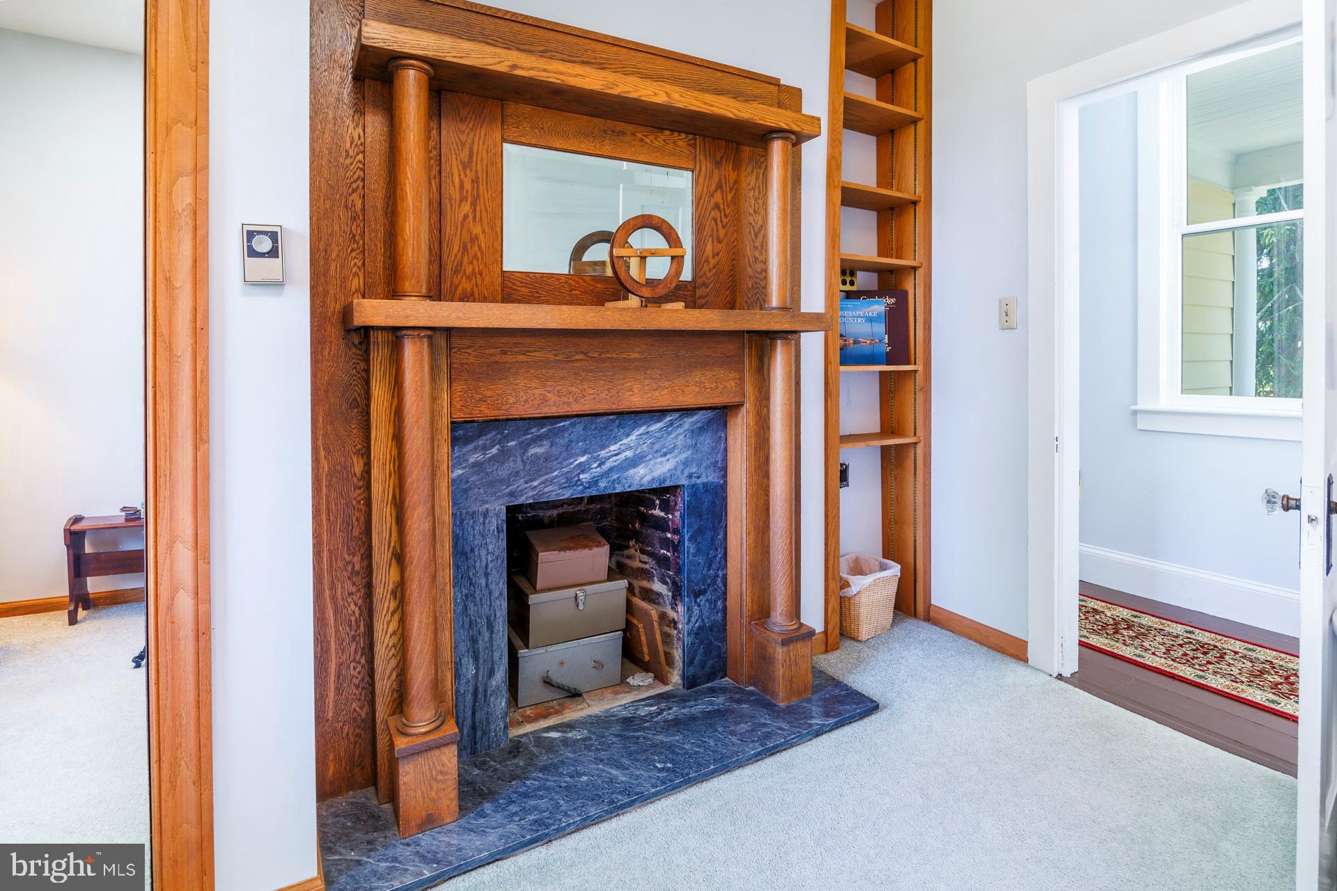 2208 Horns Point Road Cambridge, MD 21613 - Photo 29 of 39 a living room with a fireplace furniture and a window