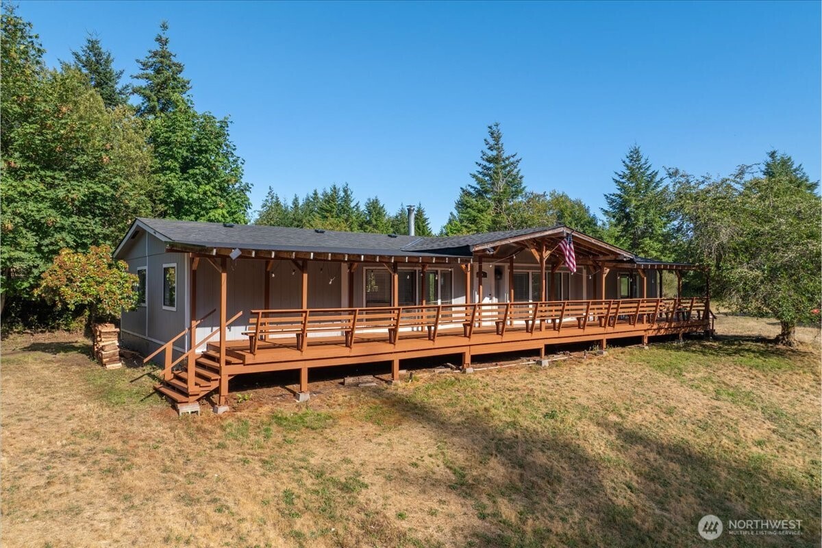 a view of a house with a yard balcony and sitting area