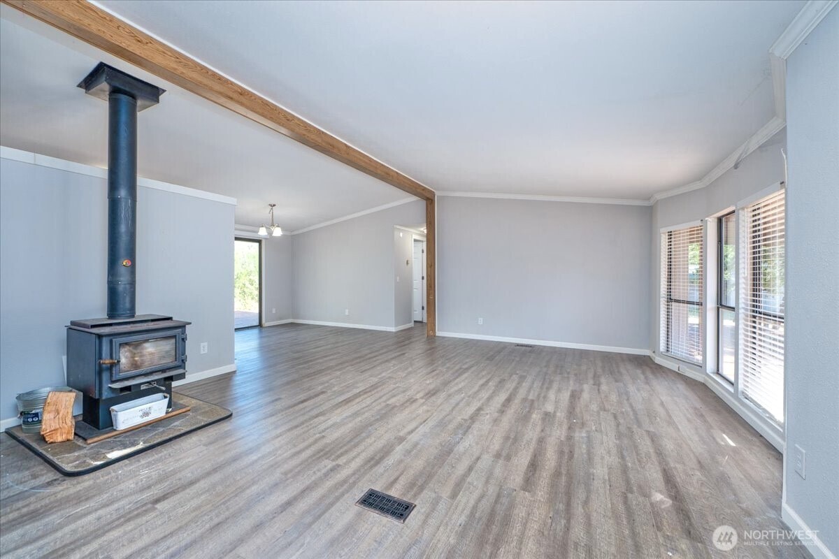 331 Frontier Road Grapeview, WA 98546 - Photo 11 of 39 a view of empty room with wooden floor and fan