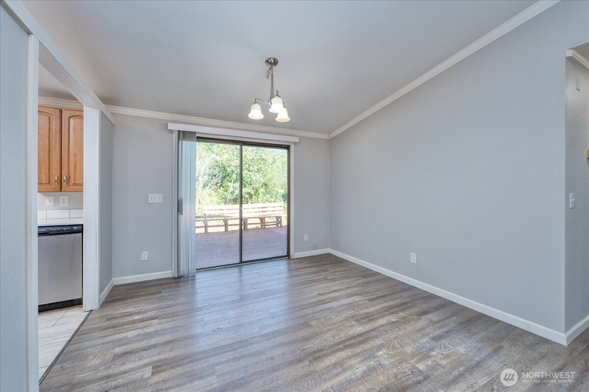 331 Frontier Road Grapeview, WA 98546 - Photo 12 of 39 wooden floor in an empty room with a window