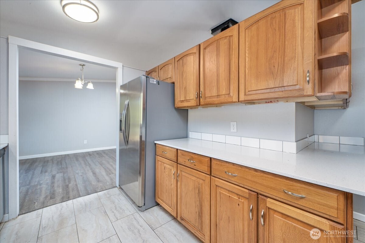 331 Frontier Road Grapeview, WA 98546 - Photo 15 of 39 a kitchen with granite countertop wooden cabinets and a sink