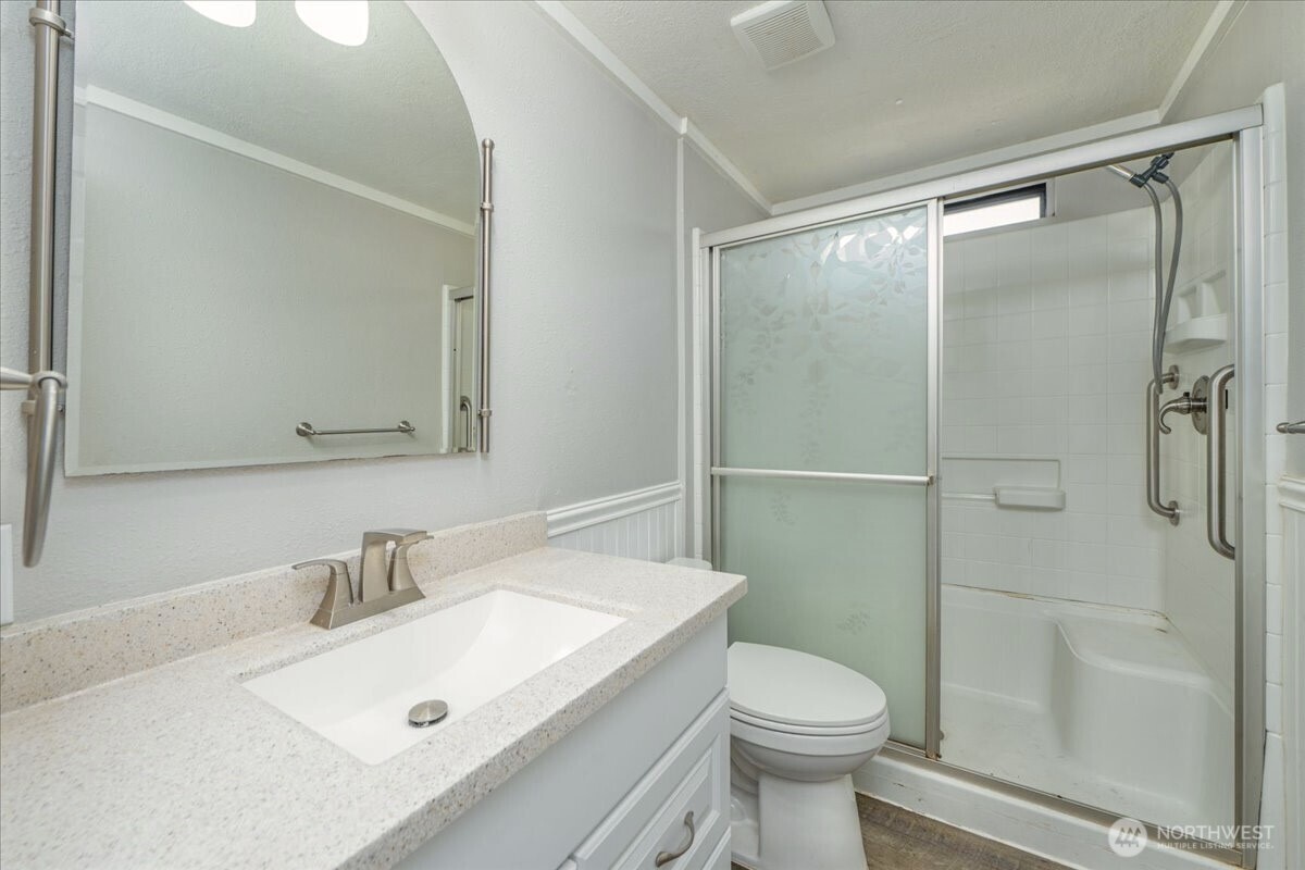 331 Frontier Road Grapeview, WA 98546 - Photo 18 of 39 a bathroom with a sink toilet and shower