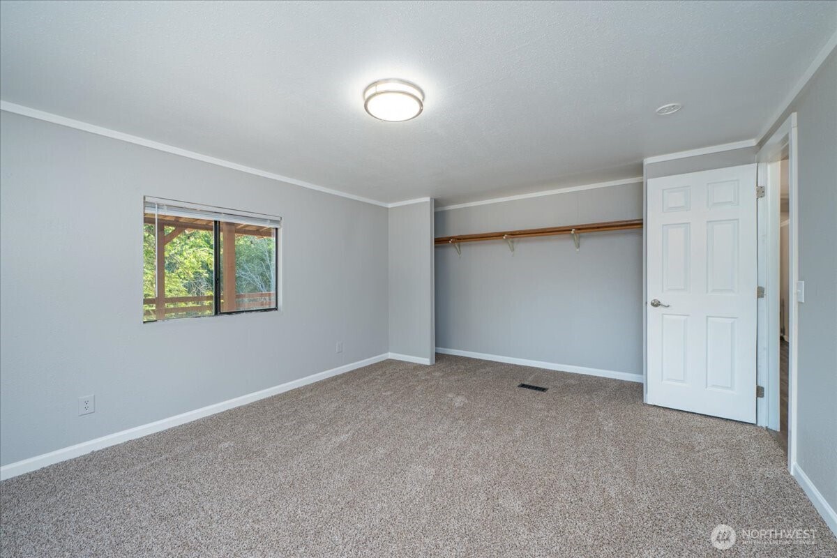 331 Frontier Road Grapeview, WA 98546 - Photo 22 of 39 a view of an empty room with a window