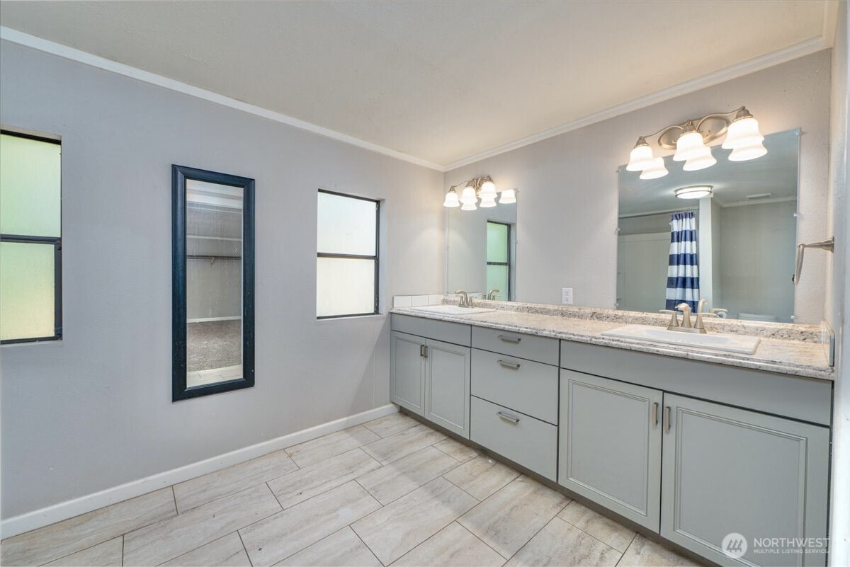 331 Frontier Road Grapeview, WA 98546 - Photo 25 of 39 a bathroom with a double vanity sink and a mirror