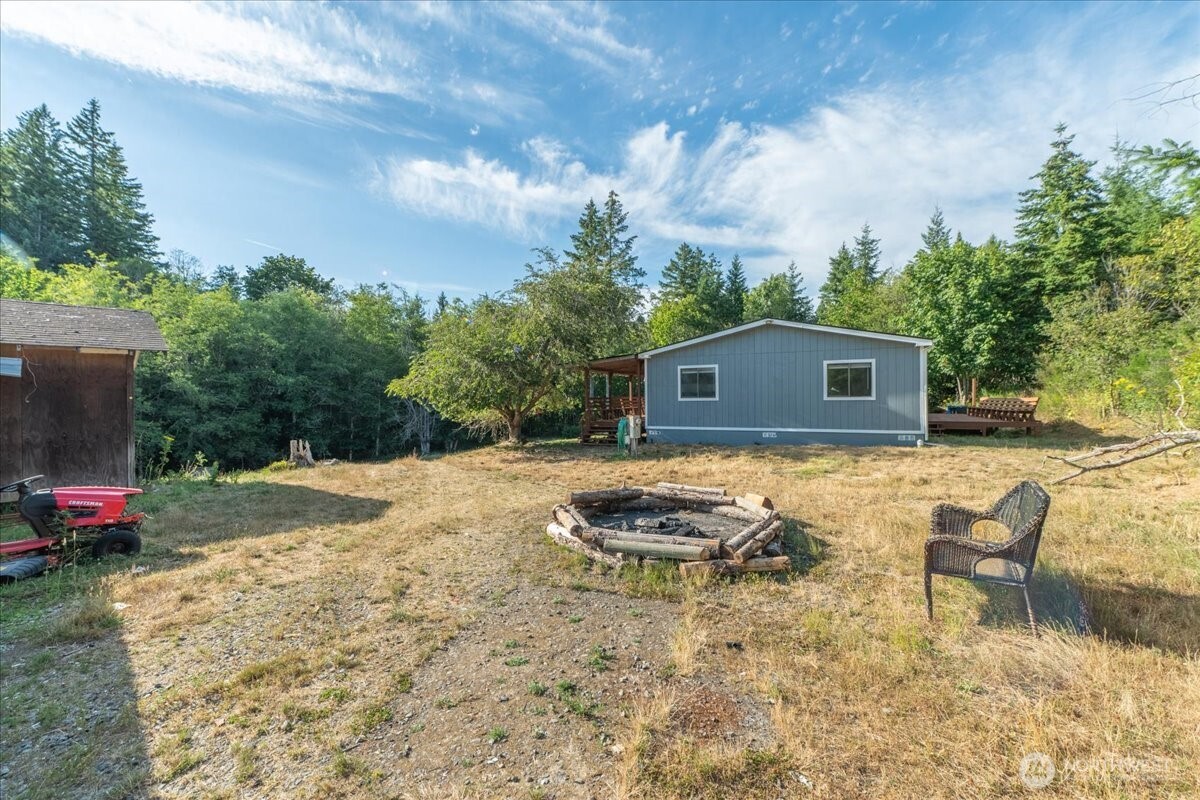 331 Frontier Road Grapeview, WA 98546 - Photo 34 of 39 a backyard of a house with yard and outdoor seating