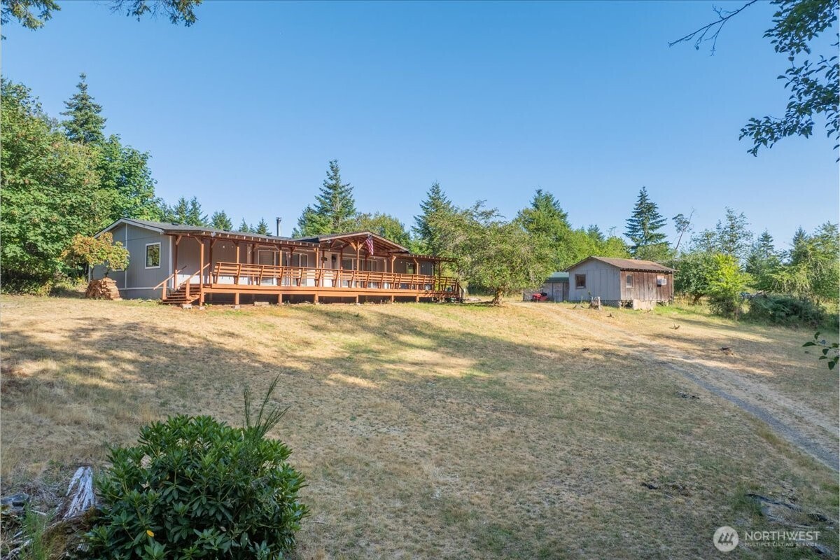 331 Frontier Road Grapeview, WA 98546 - Photo 4 of 39 a view of swimming pool with outdoor seating and house in the background
