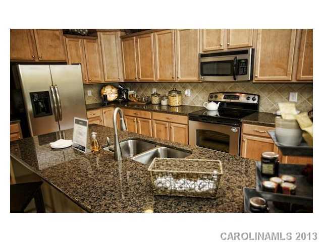 4091 Perth Road Indian Land, SC 29707 - Photo 3 of 9 a kitchen with stainless steel appliances granite countertop a stove refrigerator sink and microwave