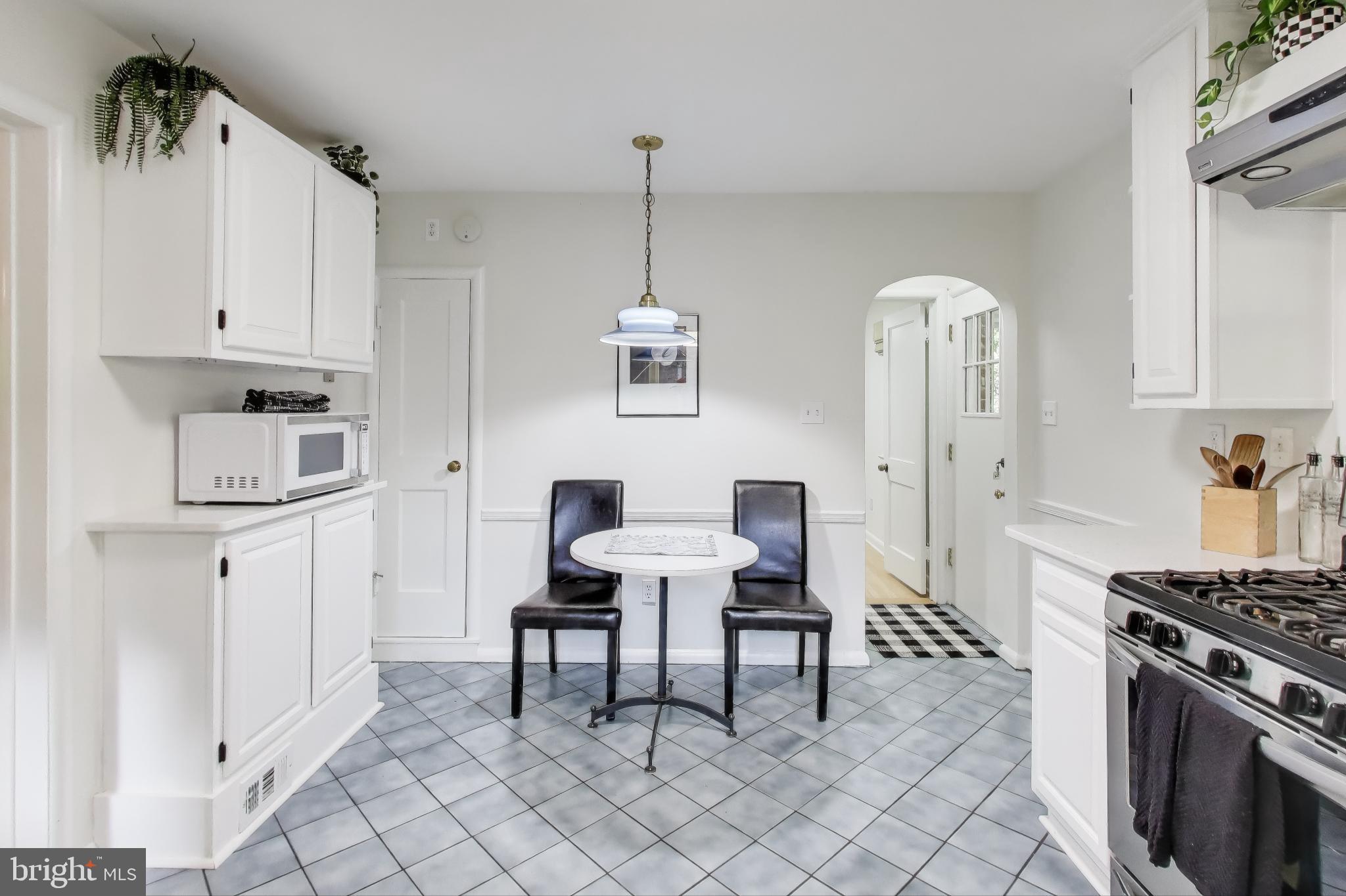 9613 Lorain Avenue Silver Spring, MD 20901 - Photo 13 of 40 a kitchen with stainless steel appliances a stove a sink and cabinets