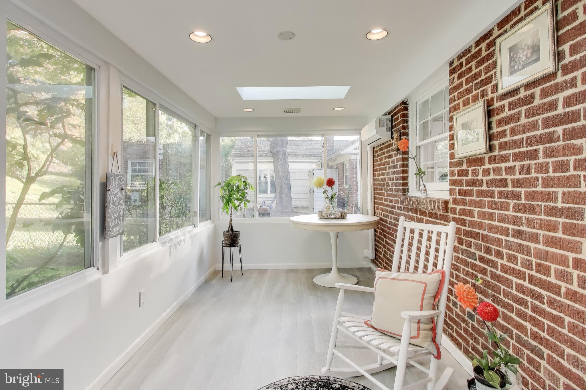 9613 Lorain Avenue Silver Spring, MD 20901 - Photo 14 of 40 a living room with a large window and furniture