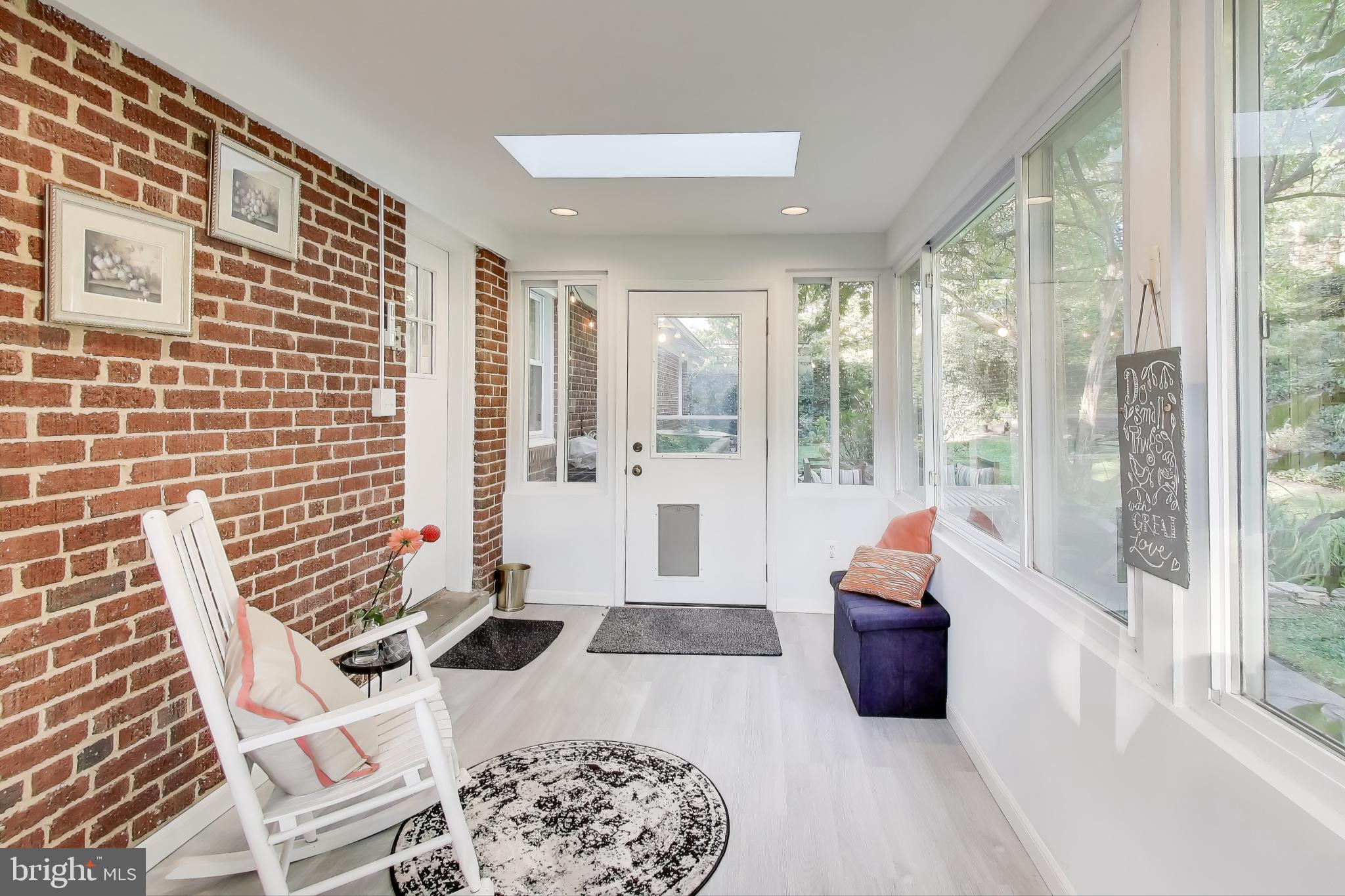 9613 Lorain Avenue Silver Spring, MD 20901 - Photo 15 of 40 a living room with furniture and a floor to ceiling window