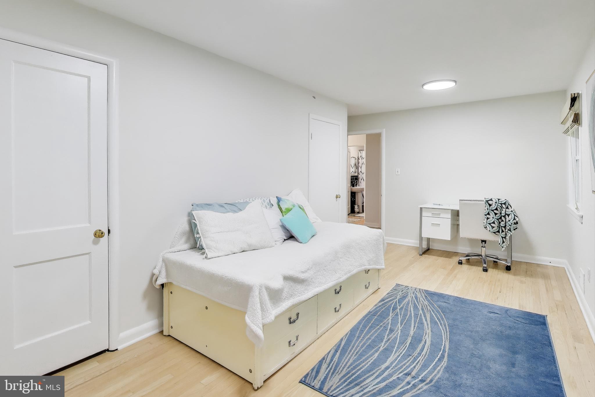 9613 Lorain Avenue Silver Spring, MD 20901 - Photo 23 of 40 a bedroom with a bed and a dresser