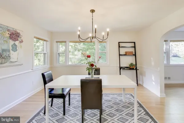 a dining room with furniture a chandelier and window