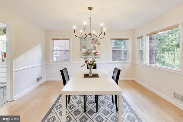 a kitchen with stainless steel appliances a stove a sink and white cabinets