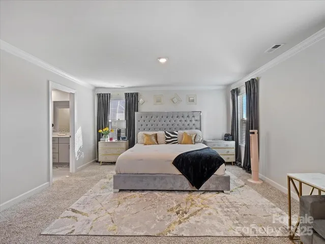 a bedroom with a large bed and a couch