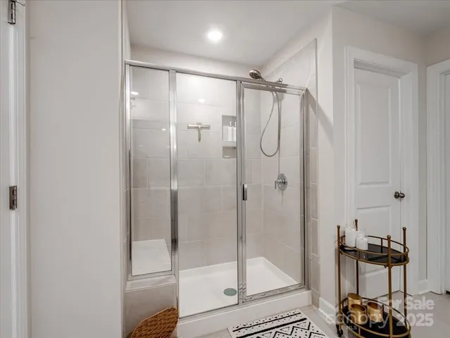 a bathroom with a glass shower door