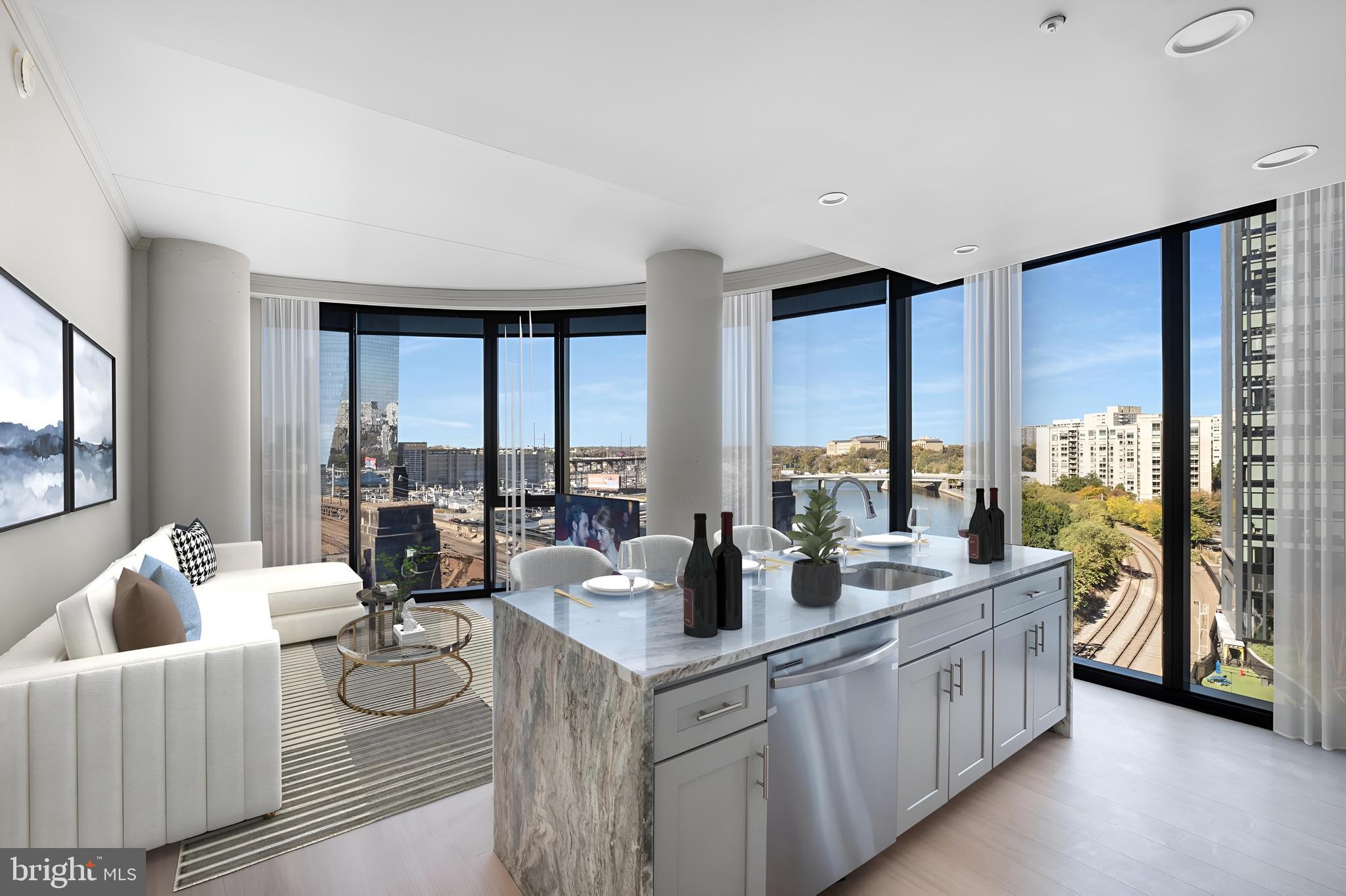 2301-61 John F Kennedy Boulevard, Unit 613 Philadelphia, PA 19103 - Photo 1 of 42 a large living room with furniture and large windows