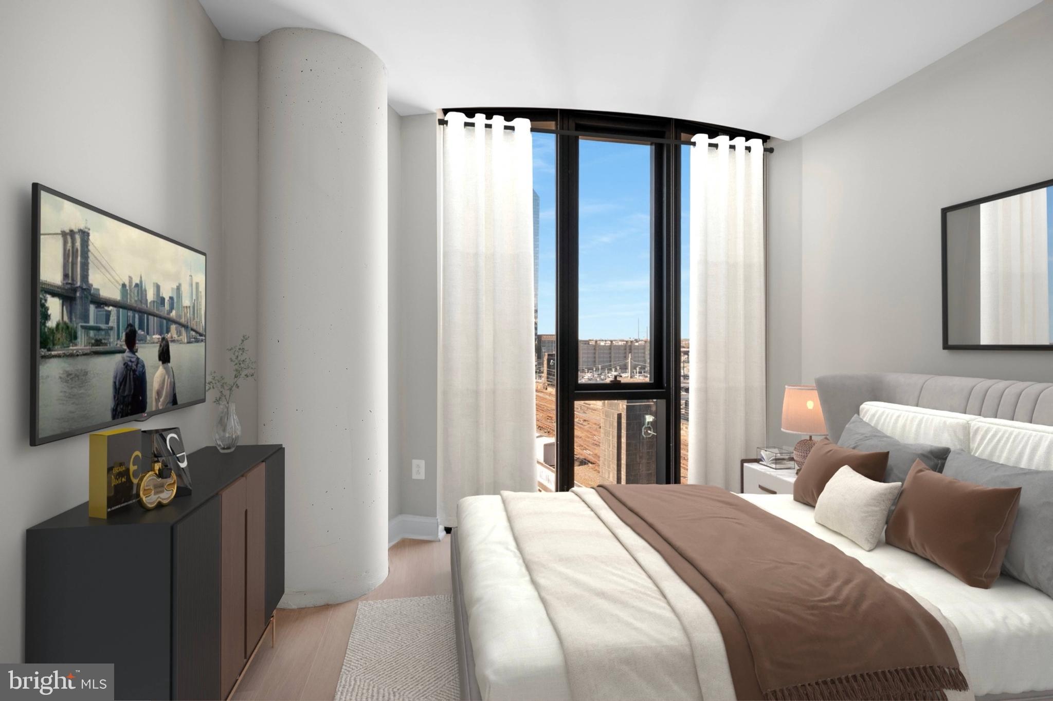 2301-61 John F Kennedy Boulevard, Unit 613 Philadelphia, PA 19103 - Photo 25 of 42 a bedroom with a bed and large windows