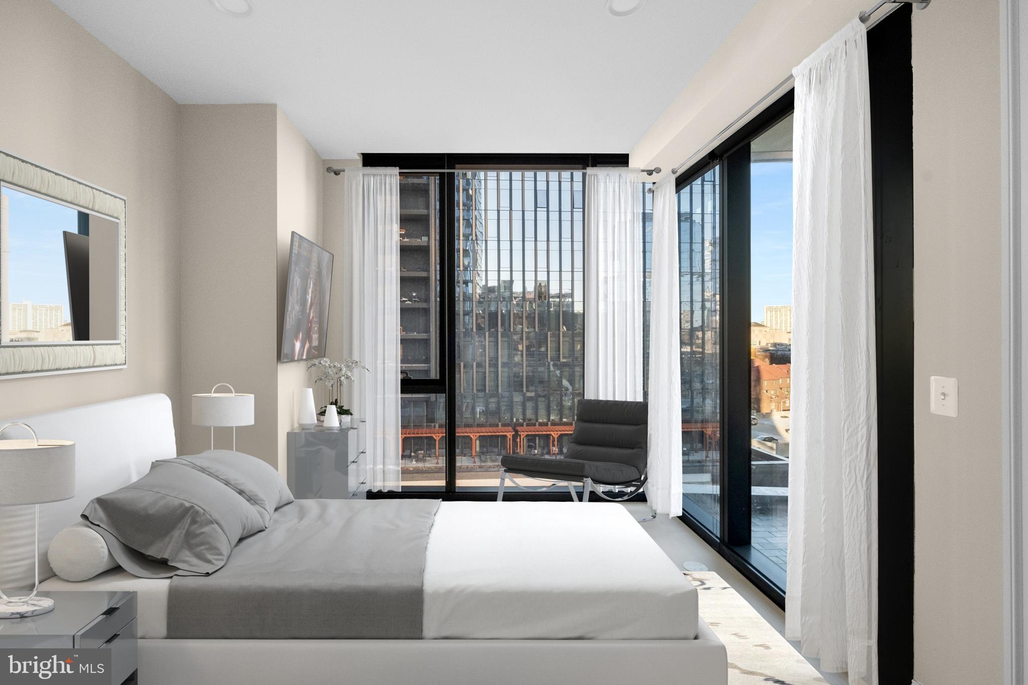 2301-61 John F Kennedy Boulevard, Unit 613 Philadelphia, PA 19103 - Photo 28 of 42 a bedroom with a large bed and a window