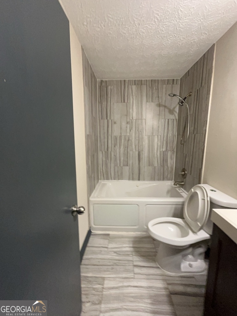 1265 Herrington Road Lawrenceville, GA 30044 - Photo 22 of 52 a bathroom with a sink a toilet and tub