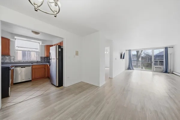 a view of kitchen with stainless steel appliances granite countertop a stove top oven a sink and dishwasher with wooden floor